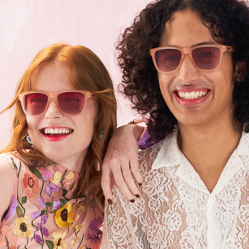 Product close up of pink square-framed sunglasses with pink gradient lenses.