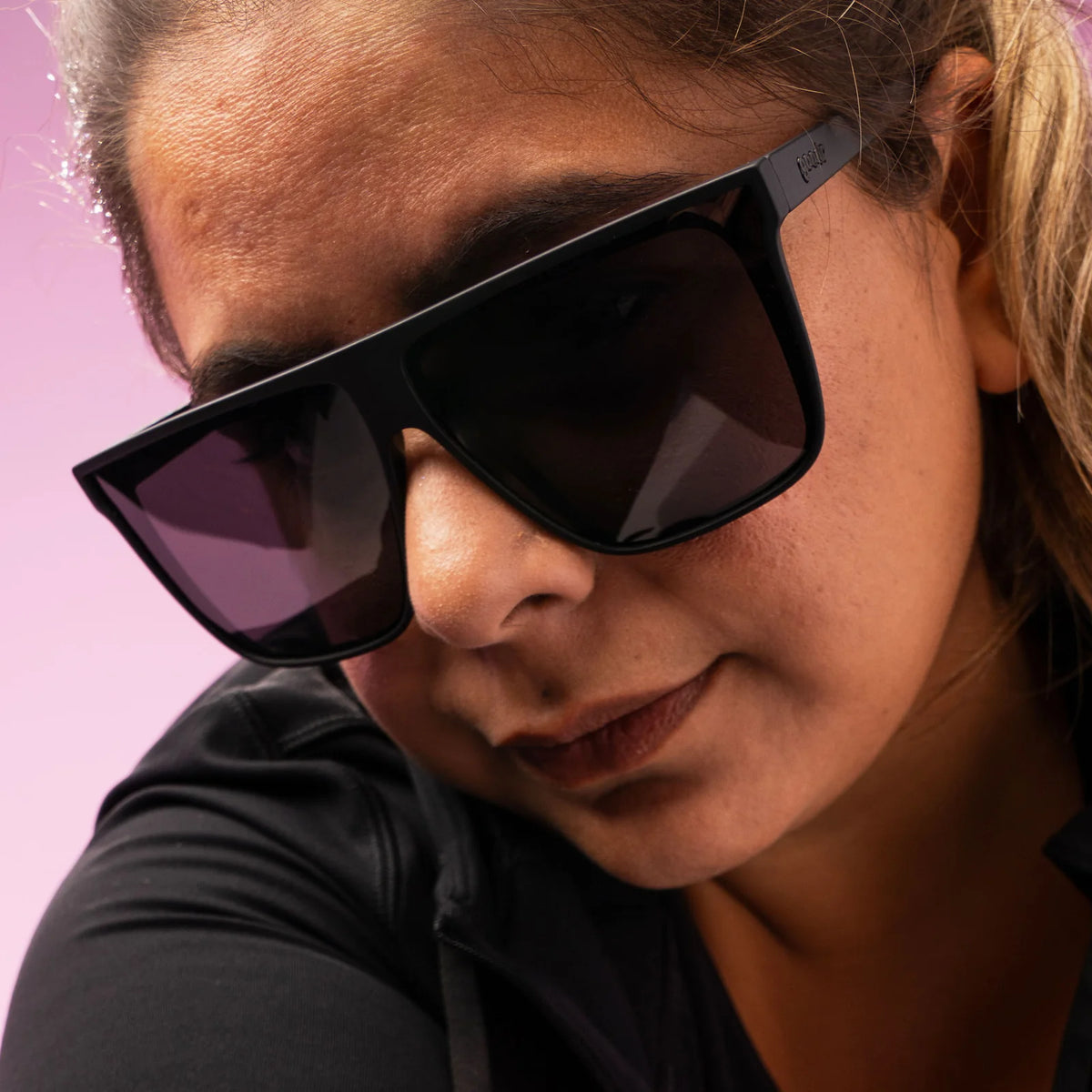 Style and fit showcase of black wide-fit, oversized sunglasses with non-reflective lenses. No slip, no bounce, all polarised.