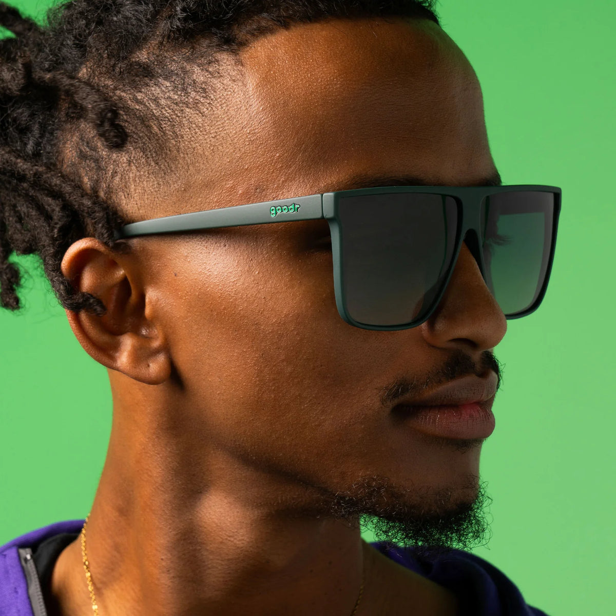 Fit and style showcase of dark green oversized, flat-top sunglasses with gradient lenses to improve ground visibility. No slip, no bounce, all polarised.
